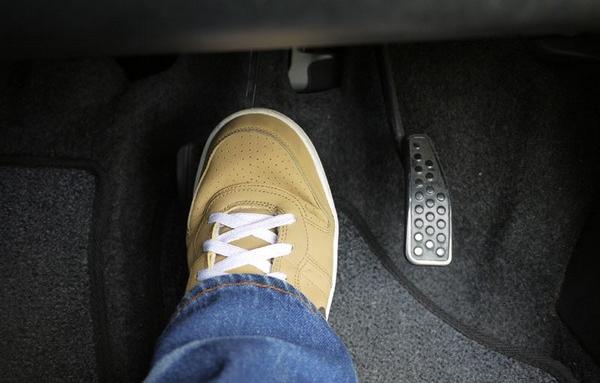 putting your foot on brake pedal