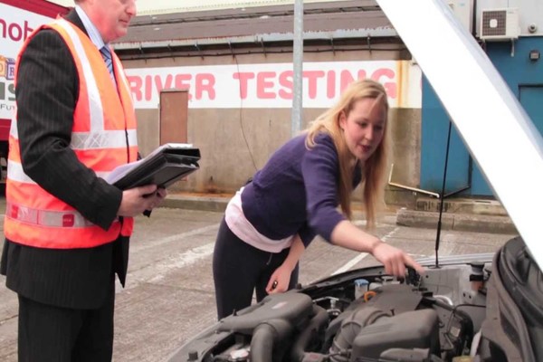 Woman performing a pre-driving check-up