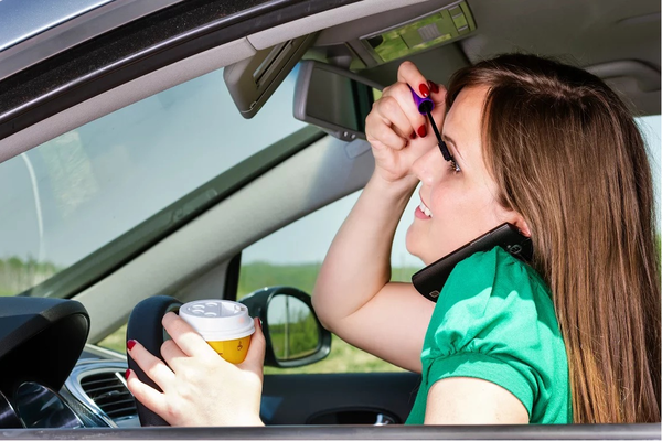 multitasking woman while driving