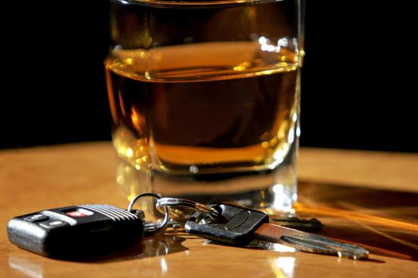 glass of alcohol next to car keys