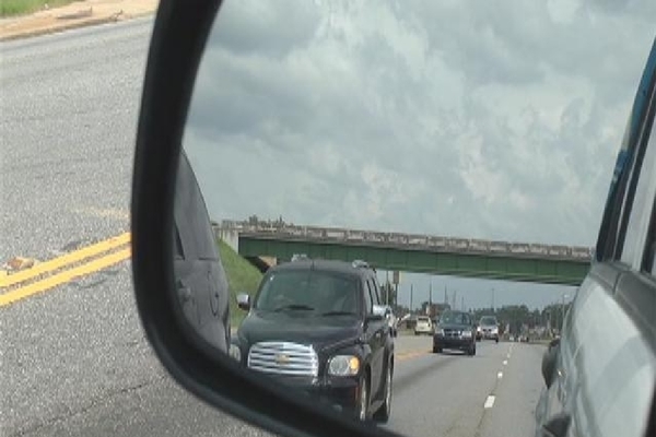 Cars in the reflection of a car's side mirror