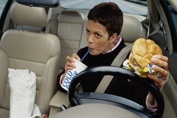 Woman eating while driving