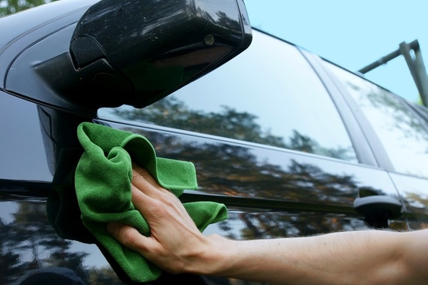 man wiping the car 