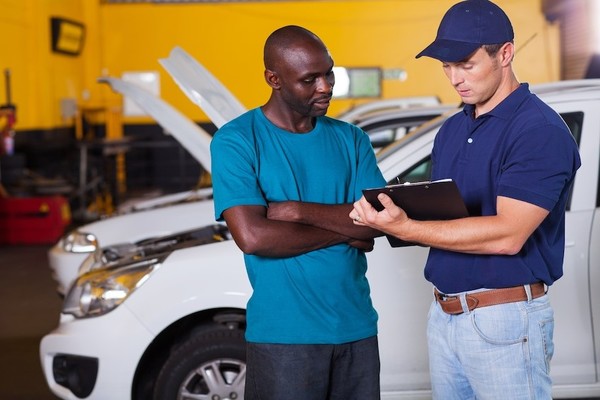 Mechanic talking a customer