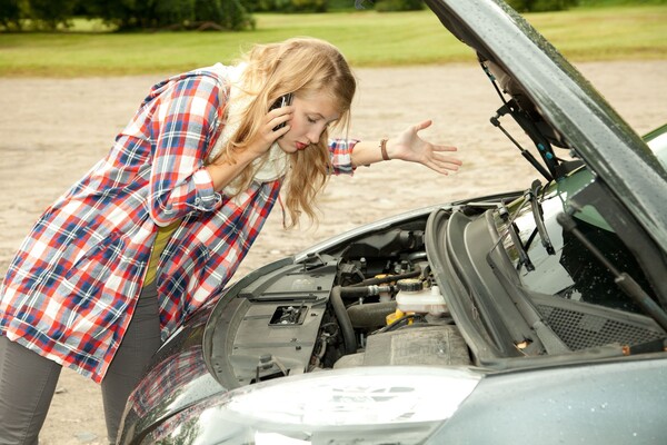 Woman checking the car engine